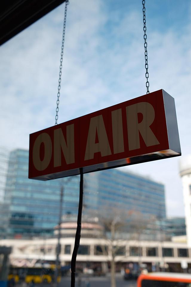 On-air podcast studio with window view of Ku'damm Berlin